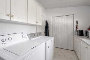 Laundry room with cabinet space and independent washer and dryer