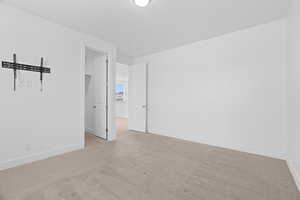 Carpeted spare room with baseboards