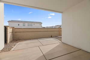 View of patio featuring fence