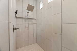 Bathroom featuring tiled shower
