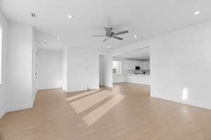 Unfurnished living room with ceiling fan, light wood-type flooring, recessed lighting, and baseboards