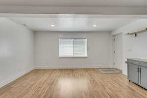 Spare room featuring recessed lighting, light wood finished floors, visible vents, and baseboards