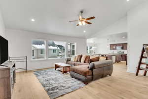 Living area with recessed lighting, light wood finished floors, baseboards, and a ceiling fan