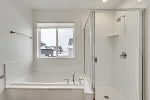 Full bath with a shower stall and a garden tub