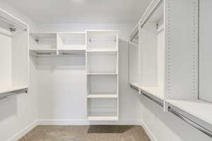 Spacious closet with carpet floors