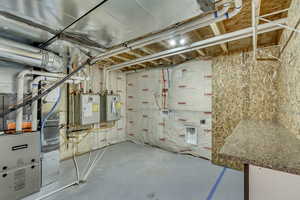 Unfinished basement featuring water heater and heating unit