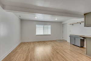 Interior space with visible vents, baseboards, a textured ceiling, light wood finished floors, and recessed lighting