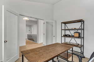 Home office with light wood finished floors and baseboards