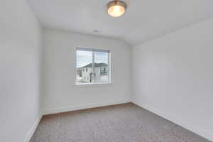 Unfurnished room with carpet, visible vents, and baseboards