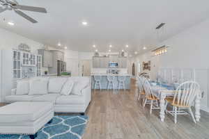 Living area with ceiling fan, light wood-type flooring, and recessed lighting