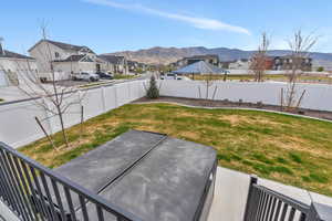 View of yard with a patio, a mountain view, a residential view, and a fenced backyard