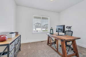 Carpeted office featuring visible vents and baseboards
