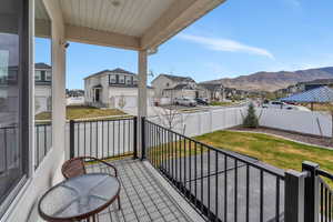 Balcony featuring a residential view and a mountain view