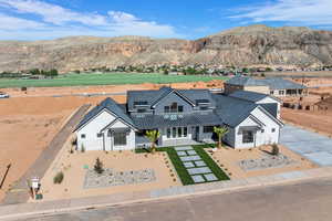 View of front facade featuring a mountain view, french doors, and solar panels