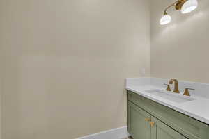Bathroom featuring vanity and baseboards