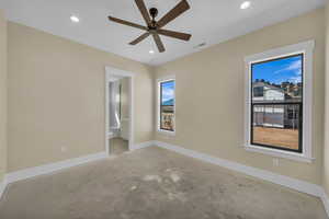 Unfurnished bedroom featuring ensuite bathroom, recessed lighting, concrete flooring, and baseboards