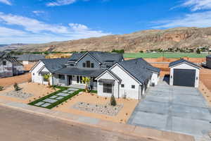 View of front of house featuring a standing seam roof, a mountain view, metal roof, and concrete driveway