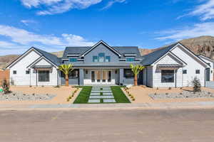 Modern farmhouse with a standing seam roof, french doors, a mountain view, and metal roof