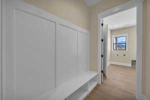 Mudroom with wood finished floors and baseboards