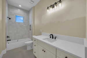 Bathroom featuring toilet, visible vents, vanity, and shower / bathing tub combination