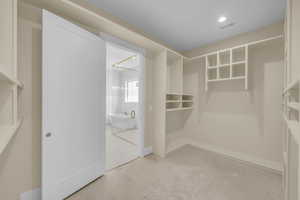 Spacious closet featuring visible vents