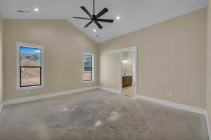 Unfurnished bedroom featuring concrete floors, visible vents, vaulted ceiling, and baseboards