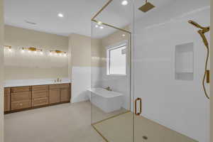 Bathroom with a sink, visible vents, a stall shower, recessed lighting, and a freestanding tub