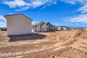 Rear view of house with stucco siding