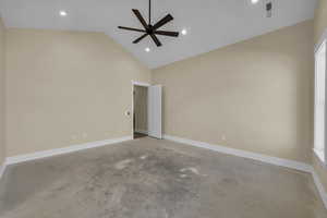 Spare room featuring concrete floors, visible vents, recessed lighting, a ceiling fan, and high vaulted ceiling