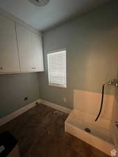 Interior space with baseboards, visible vents, cabinet space, and dark tile patterned flooring