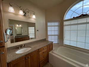 Full bathroom featuring a bath, tile patterned flooring, and vanity