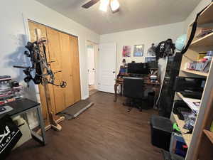 Office area with wood finished floors and a ceiling fan