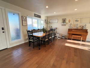 Dining space with wood finished floors and recessed lighting