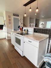Kitchen featuring pendant lighting, white cabinetry, white range with electric cooktop, and dark wood finished floors