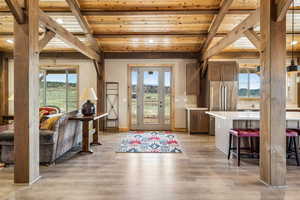 Foyer featuring beam ceiling, wooden ceiling, light wood-type flooring, and recessed lighting