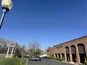 View of building exterior with uncovered parking