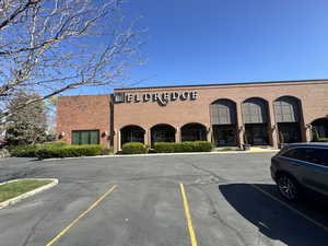 View of building exterior with uncovered parking