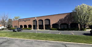 View of building exterior with uncovered parking