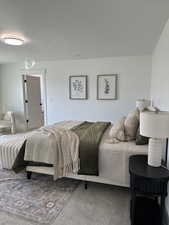 Bedroom featuring a textured ceiling and carpet