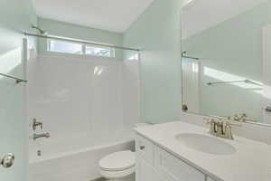 Full bathroom with toilet,  shower combination, and vanity