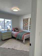 Bedroom featuring a textured ceiling and carpet floors