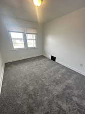 Carpeted empty room with baseboards. 983 29th St.