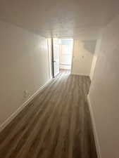 Interior space featuring baseboards and dark wood-style flooring. 983 29th St