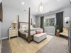 Bedroom featuring baseboards, visible vents, light carpet, and recessed lighting