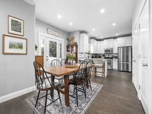 Dining room featuring baseboards, recessed lighting, and dark wood-type flooring