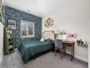 Bedroom featuring visible vents, baseboards, wallpapered walls, and carpet floors