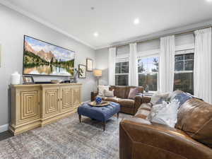 Living area featuring crown molding, recessed lighting, and baseboards