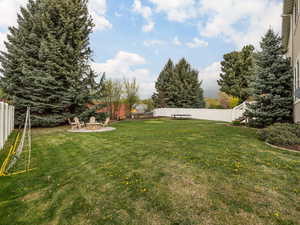 View of yard with an outdoor fire pit and a fenced backyard