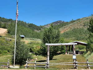 View of home's community featuring fence and a rural view