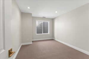 Spare room featuring recessed lighting, carpet floors, visible vents, and baseboards
